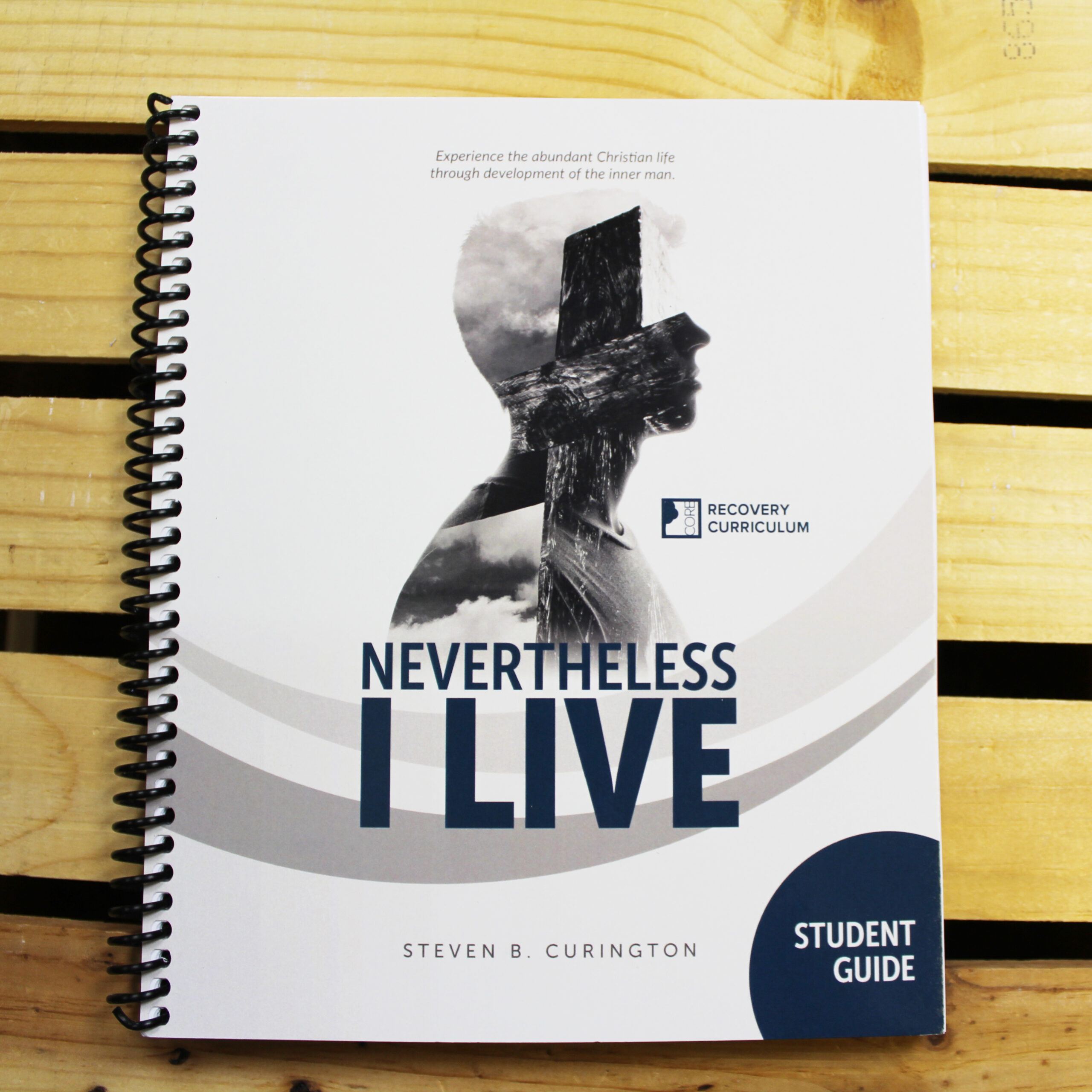 Nevertheless, I Live student guide on a wood tabletop