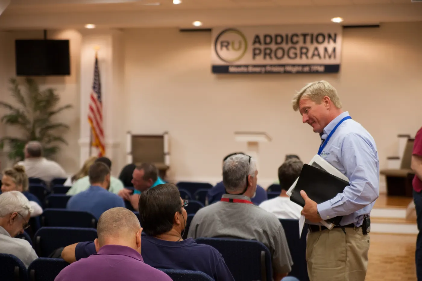 RU director speaking with participants during a recovery meeting